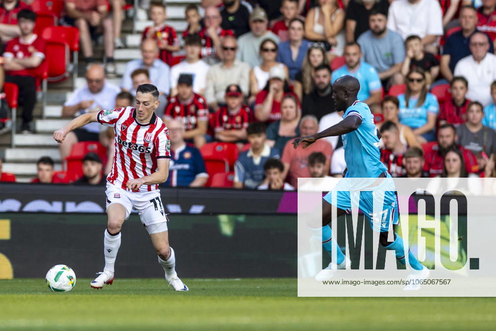 12th August 2025; Bet365 Stadium, Stoke, Staffordshire, England; EFL Carabao Cup Football, Stoke City versus Walsall; Robert Bozenik of Stoke City under pressure from Albert Adomah of Walsall TimxWilliams Content restricted for UK based newspaper
