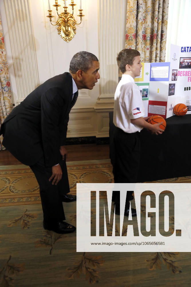 Washington, District Of Columbia, U.S - United States President Barack Obama catches a ball from the Basketball Catapult a science project of Brooke Bohn (unseen), Daisjaughn Bass (unseen) and Gerry McManus (r), from Hudson Massachusetts, winners of the Raytheon and New England Patriots Science of Sports during the 2014 White House Science Fair at the White House, Washington DC, Tuesday May 27, 2014. The Fair celebrates the winners of STEM (science, technology, engineering and math) competitions across the country.