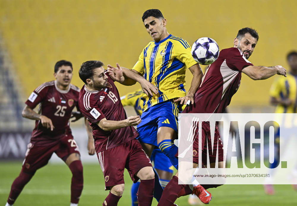 AFC CHAMPIONS LEAGUE ELITE, AL GHARAFA SC V AL WAHDA FC Jamal Hamed Mayor (C) of Al Gharafa SC and Sasa Ivkovic of Al Wahda FC in action during the AFC Champions League elite west football match between Qatar s Al Gharafa SC and United Arab Emirates Al Wahda FC at Thani Bin Jassim Stadium in Doha, Qatar on December 22, 2025. DOHA Qatar