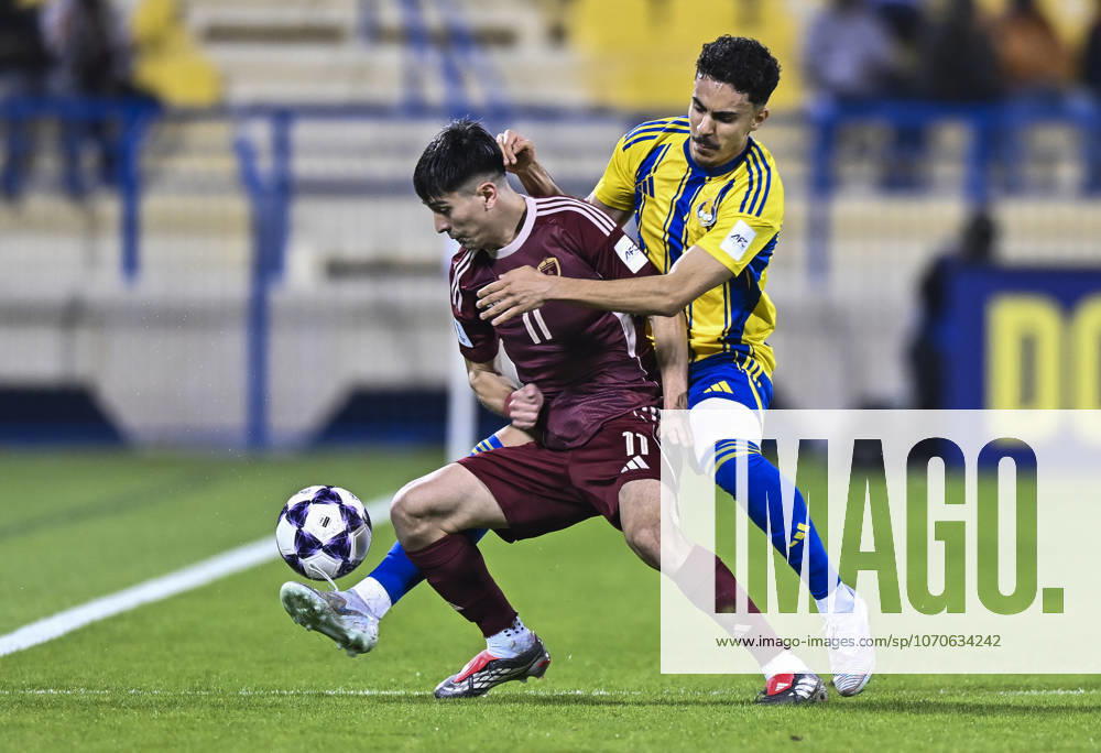 AFC CHAMPIONS LEAGUE ELITE, AL GHARAFA SC V AL WAHDA FC Ayoub Mohamed Aloui (R) of Al Gharafa SC and Facundo Kruspzky of Al Wahda FC in action during the AFC Champions League elite west football match between Qatar s Al Gharafa SC and United Arab Emirates Al Wahda FC at Thani Bin Jassim Stadium in Doha, Qatar on December 22, 2025. DOHA Qatar
