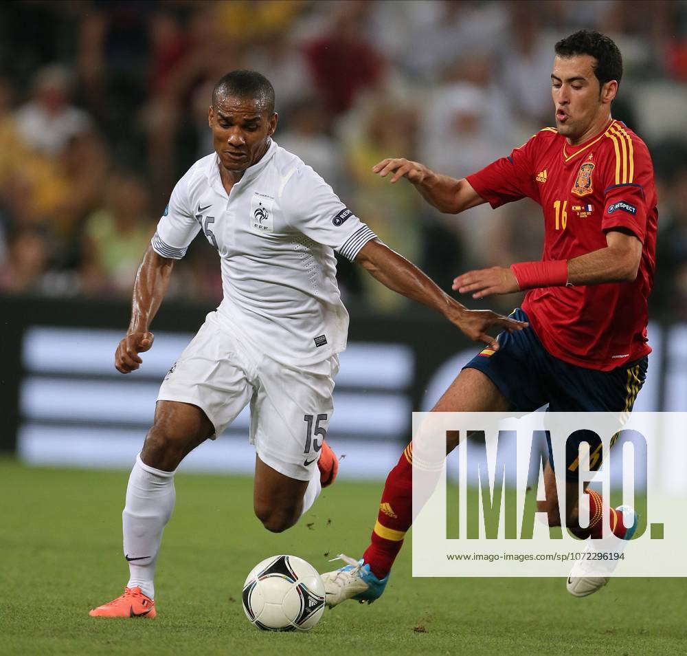 Spain V France, UEFA EURO, EM, Europameisterschaft,Fussball 2012 Quarter Final Florent Malouda of France and Sergio Busquets of Spain challenge during the UEFA Euro 2012 Quarter Final match between Spain and France at Donbass Arena on June 23, 2012 in Donetsk, Ukraine. Donetsk Donbass Arena Ukraine Ukraine