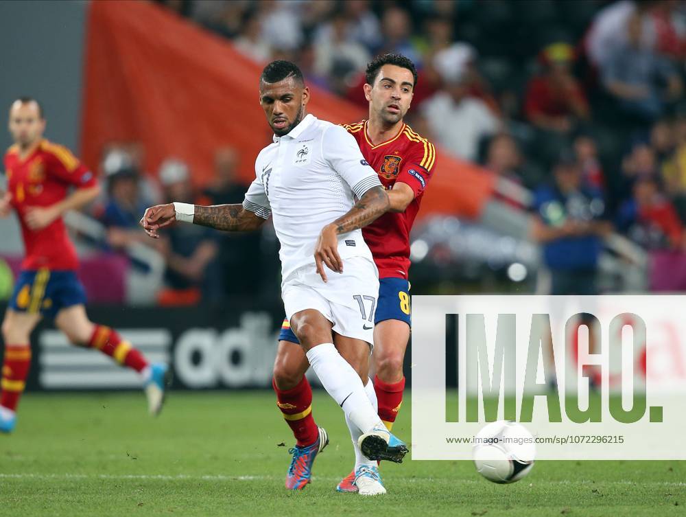 Spain V France, UEFA EURO, EM, Europameisterschaft,Fussball 2012 Quarter Final Xavi Hernandez of Spain and Yann M Vila of France challenge during the UEFA Euro 2012 Quarter Final match between Spain and France at Donbass Arena on June 23, 2012 in Donetsk, Ukraine. Donetsk Donbass Arena Ukraine Ukraine