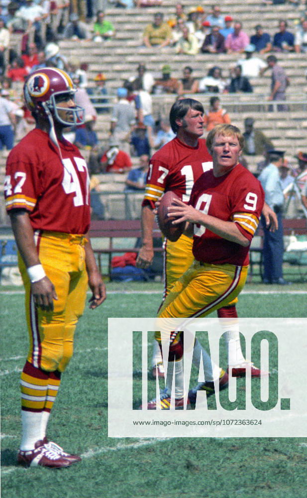 Washington Redskins quarterback Sonny Jurgensen 9 warms-up prior to the game against the Miami Dolphins at RFK Stadium in Washington, DC on October 13, 1974. Behind Jurgensen is Redskins quarterback Billy Kilmer 17. Redskins running back Duane Thomas 47 looks on from left.The Redskins won the game 20 - 17 Washington USA - ZUMAs152 19741013_faa_s152_006