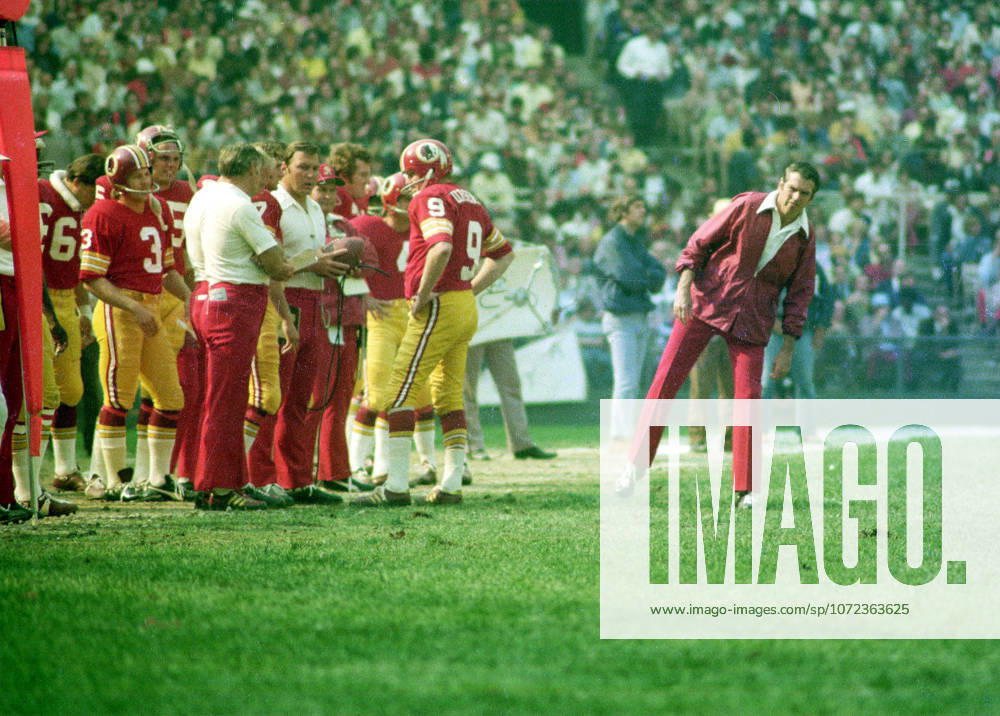 Washington Redskins head coach George Allen, right, looks over the situation as quarterback Sonny Jurgensen 9 and coaches, left, discuss strategy during the game against the Miami Dolphins at RFK Stadium in Washington, DC on October 14, 1974. The Redskins won the game 20 - 17 Washington USA - ZUMAs152 19741014_faa_s152_001