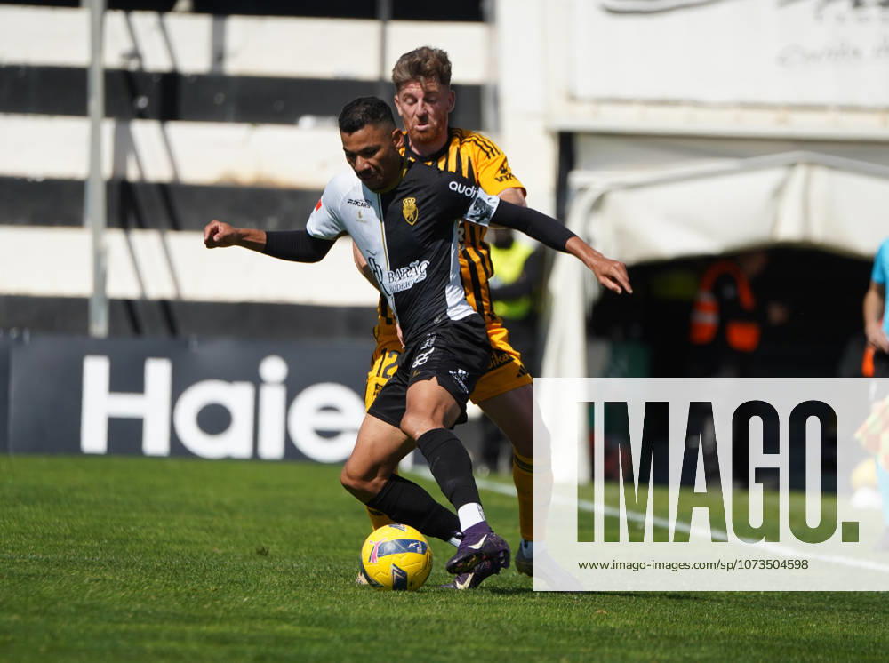 Liga Portugal 2 Meu Super Round 24 football match between SC Farense and Lusitania Lourosa FC, Faro, Portugal Faro, Portugal. 1 st Mar, 2026. Claudio Falcao of SC Farense trying to get pass Arsenio Nunes of Lourosa FC, during the SC Farense 2 - 1 Lusitano Lourosa FC Round 24 match for the football Liga Portugal 2 Meu Super. Nuno Pires Veloso Alamy Live News