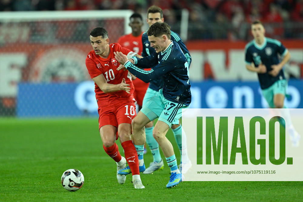 Basel, St.Jakob-Park, 27.03.26, GER, Herren, Laenderspiel: Schweiz - Deutschland Bild: v.li. im Zweikampf Granit XHAKA (Schweiz) und Florian WIRTZ (Deutschland) UEFA regulations prohibit any use of photographs as image sequences and or quasi-video. Basel Schweiz