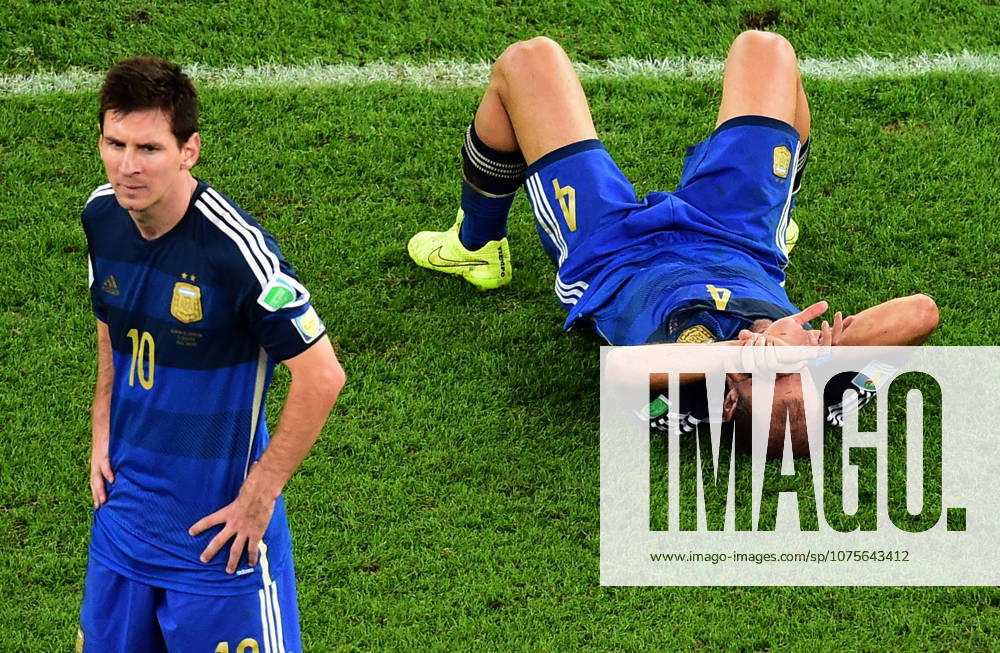 Rio De Janeiro, BRAZIL - Argentina s Pablo Zabaleta lies on the pitch as Lionel Messi stands beside him after the World Cup final soccer match between Germany and Argentina at the Maracana Stadium in Rio de Janeiro, Brazil, Sunday, July 13, 2014. Mario Goetze volleyed in the winning goal in extra time to give Germany its fourth World Cup title with a 1-0 victory over Argentina on Sunday.