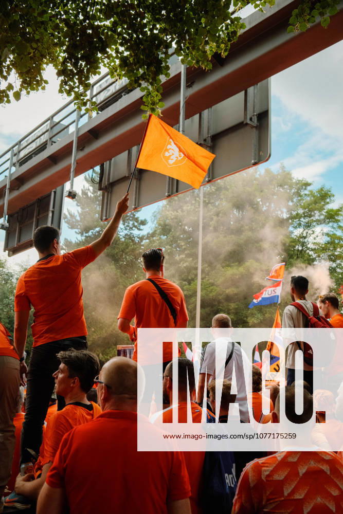 Football, UEFA EURO, EM, Europameisterschaft,Fussball 2024, Netherlands Fan March Netherlands fans in orange shirts wave Dutch flags and an orange lion flag amid smoke during the fan march in Dortmund, Germany, before the UEFA Euro 2024 semi-final between the Netherlands and England. Dortmund Dortmund NRW Germany