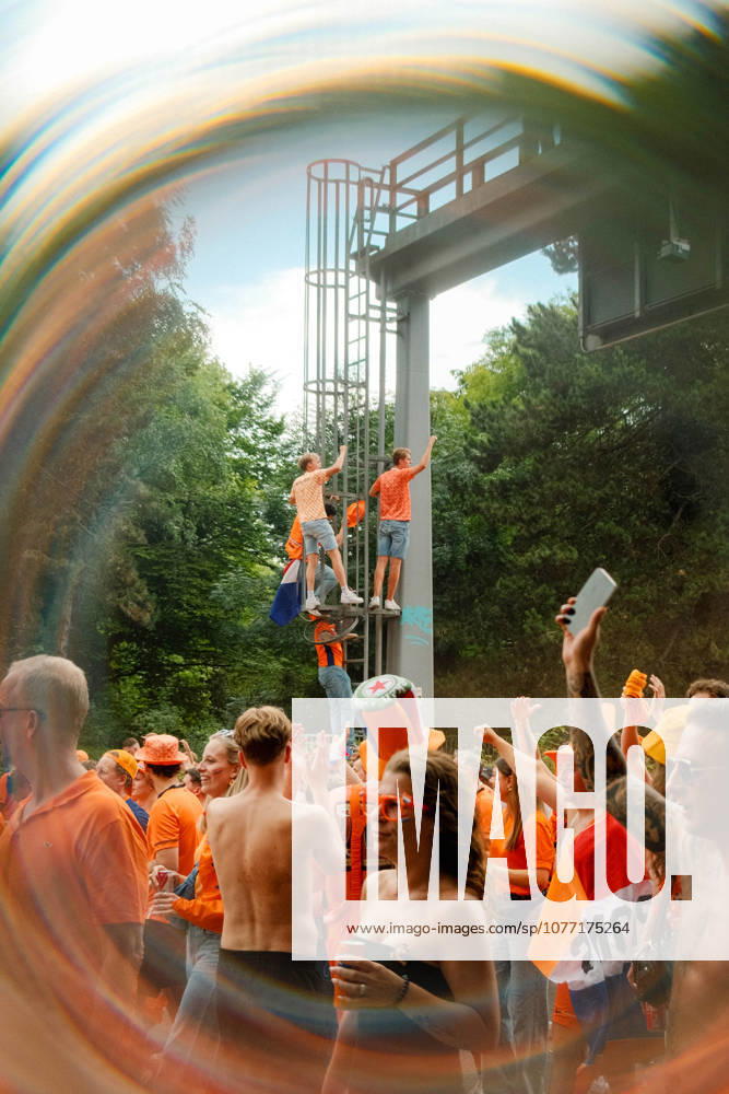 Football, UEFA EURO, EM, Europameisterschaft,Fussball 2024, Netherlands Fan March Netherlands fans celebrate in a packed orange crowd during the fan march in Dortmund, Germany, with supporters climbing a roadside structure before the UEFA Euro 2024 semi-final match against England. Dortmund Dortmund NRW Germany