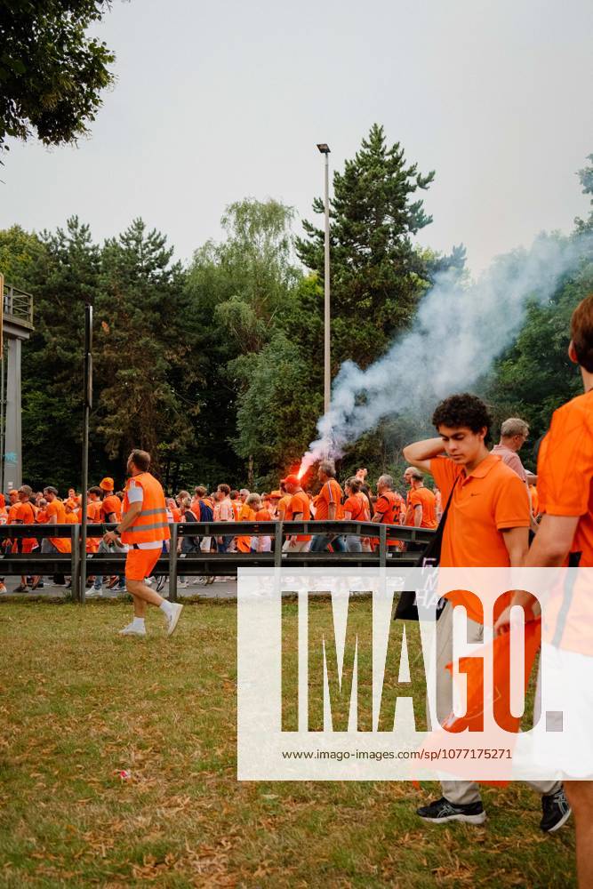 Football, UEFA EURO, EM, Europameisterschaft,Fussball 2024, Netherlands Fan March Netherlands supporters in orange walk along the fan march route in Dortmund, Germany, as smoke from a flare rises above the crowd before the UEFA Euro 2024 semi-final against England. Dortmund Dortmund NRW Germany