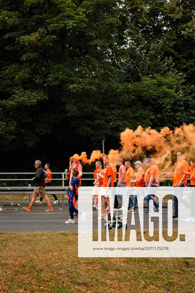 Football, UEFA EURO, EM, Europameisterschaft,Fussball 2024, Netherlands Fan March Netherlands supporters in orange shirts walk along the road as orange smoke rises above the fan march in Dortmund, Germany, ahead of the UEFA Euro 2024 semi-final match between the Netherlands and England. Dortmund Dortmund NRW Germany