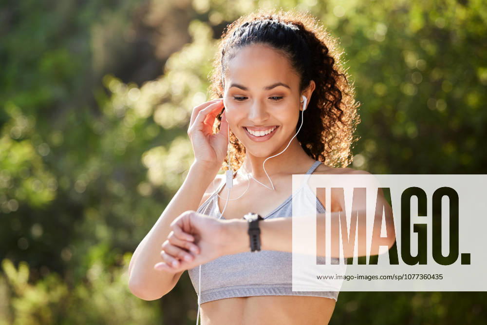 Music, time and watch with runner woman outdoor in park for summer fitness, training or workout. Improvement, progress and tracking with happy sports athlete running in nature for cardio exercise. (License=RF) 21837161 ,model released, Symbolfoto