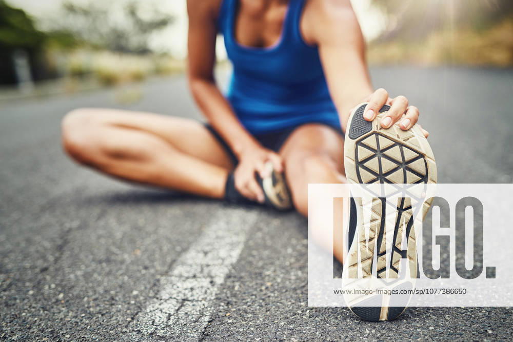 Stretching leg, floor and woman in road with fitness for running challenge, marathon training or cardio in morning. Runner, warm up and athlete getting ready for workout, exercise or sports activity. (License=RF) 21871854 ,model released, Symbolfoto