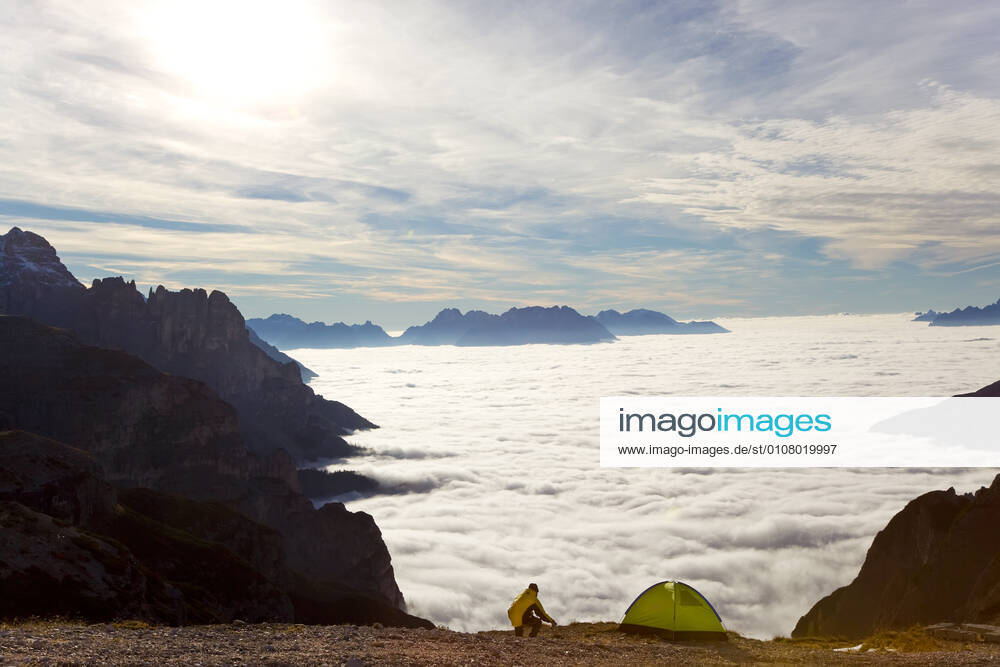 Man and tent above the clouds, Trentino-Alto Adige, South Tyrol in Bolzano district, Alta Pusteria, Hochpustertal,Sexten Dolomites, Italy Man and tent above the clouds, Trentino-Alto Adige, South Tyrol in Bolzano district, Alta Pusteria, Hochpustertal,Sexten Dolomites, Italy Man and tent above the clouds, Trentino-Alto Adige, South Tyrol in Bolzano district, Alta Pusteria, Hochpustertal,Sexten Dolomites, Italy
