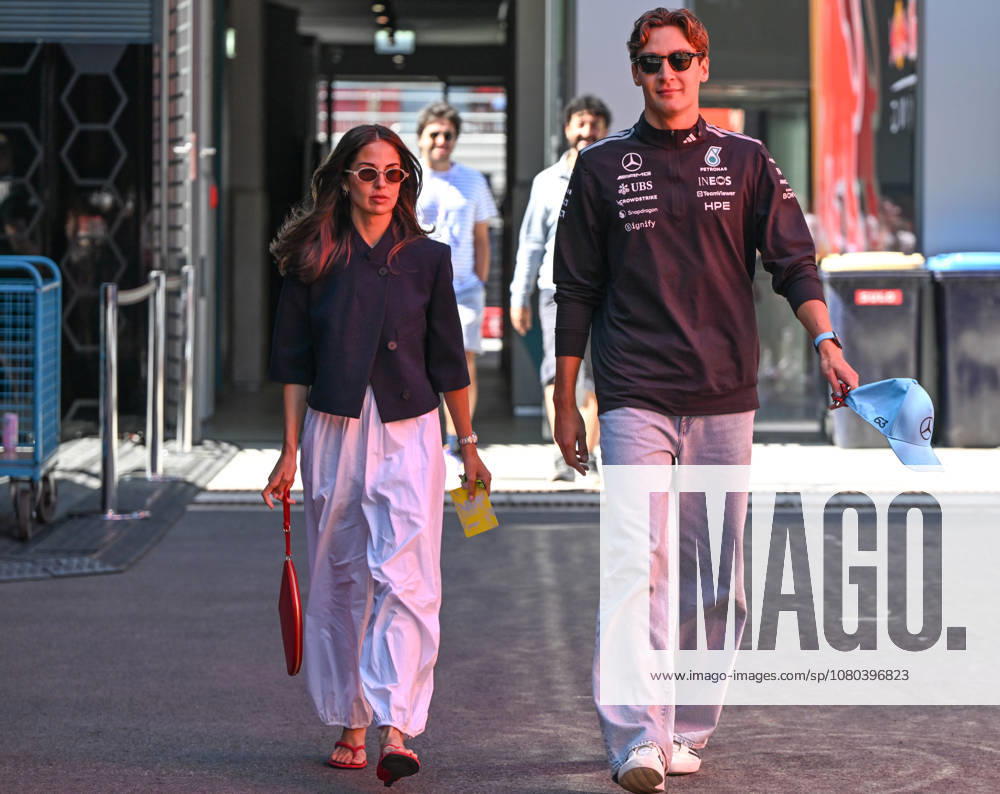 F1 Grand Prix Of Hungary 2026 MOGYOROD, HUNGARY - JULY 25: George Russell of Great Britain and Mercedes-AMG Petronas F1 Team walks through the paddock with his girlfriend Carmen Montero Mundt ahead of Free Practice 3 (FP3) during the Formula 1 Hungarian Grand Prix 2026 at Hungaroring on July 25, 2026 in Mogyorod, Hungary. Mogyorod Hungary