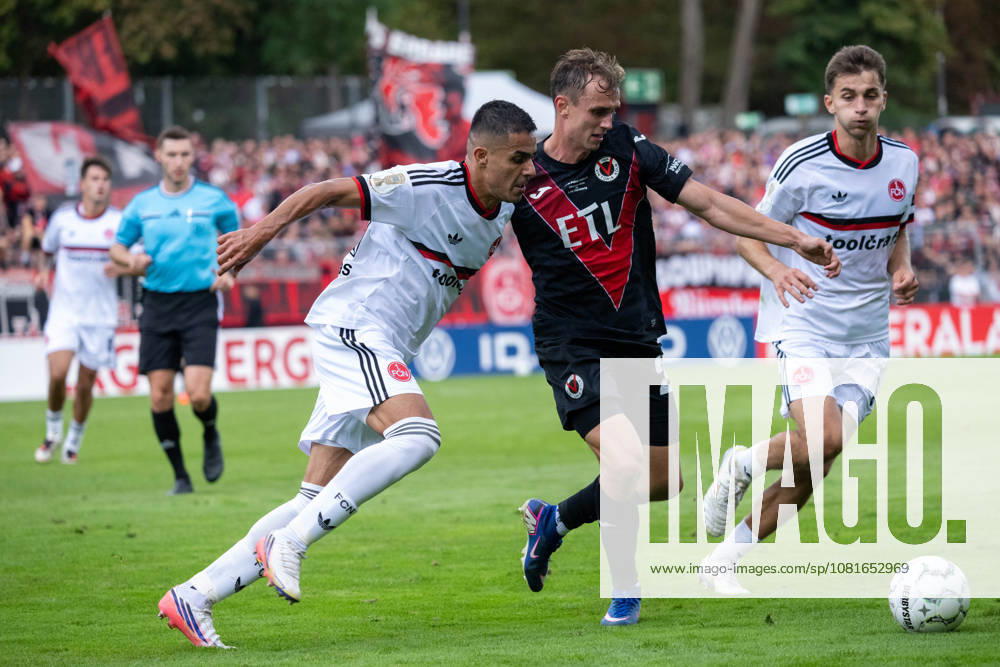 Zweikampf zwischen Ioannis Masouras (1. FC Nuernberg, 21), Kilian Jakob (Viktoria Koeln, 26) und Adam Markhiyev (1. FC Nuernberg, 06). Viktoria Koeln vs. 1. FC Nuernberg, Fussball, DFB-Pokal, 1. Runde, Saison 2026 2027, 22.08.2026 DFL DFB Regulations prohibit any use of Photographs as image sequences and or Quasivideo Viktoria Koeln vs. 1. FC Nuernberg, Fussball, DFB-Pokal, 1. Runde, Saison 2026 2027, 22.08.2026 Koeln