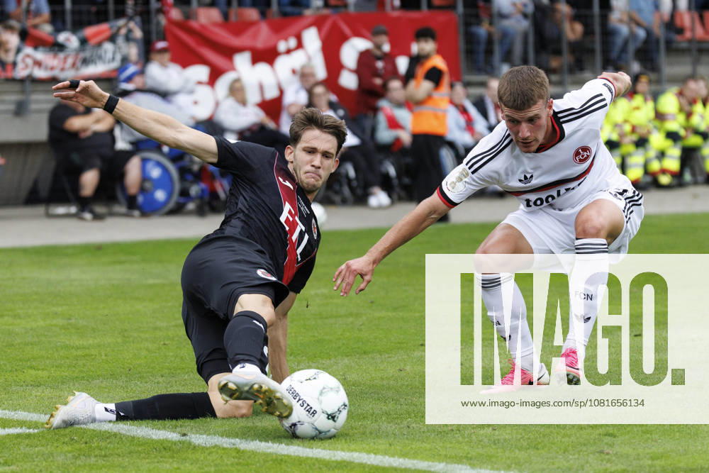 Pascal Fallmann (Viktoria Koeln, 28) and Tobias Heß (1. FC Nuernberg, 43) during the DFB-Cup match between Viktoria Koeln vs. 1. FC Nuernberg at the Sportpark Hoehenberg on August 22, 2026 in Koeln, Germany. DFL REGULATIONS PROHIBIT ANY USE OF PHOTOGRAPHS AS IMAGE SEQUENCES AND OR QUASI-VIDEO. Nordrhein-Westfalen Germany