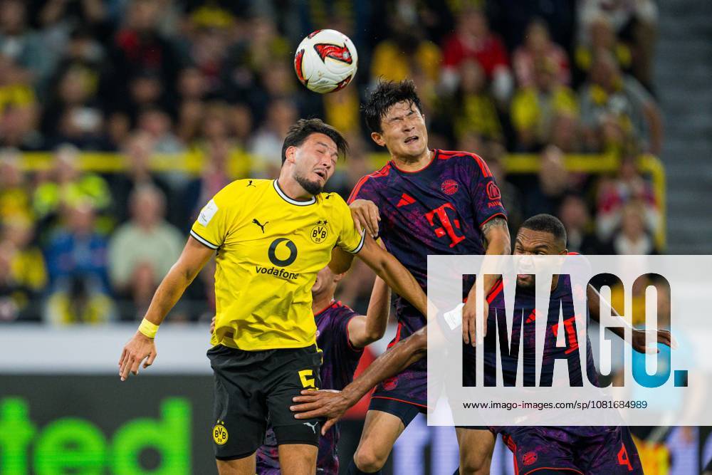 Fußball, 2026 2027, Franz-Beckenbauer-Supercup, Borussia Dortmund - FC Bayern München: (L-R) Ramy Bensebaini (Dortmund), Min-jae Kim (München), Jonathan Tah (München) DFB REGULATIONS PROHIBIT ANY USE OF PHOTOGRAPHS AS IMAGE SEQUENCES AND OR QUASI-VIDEO.