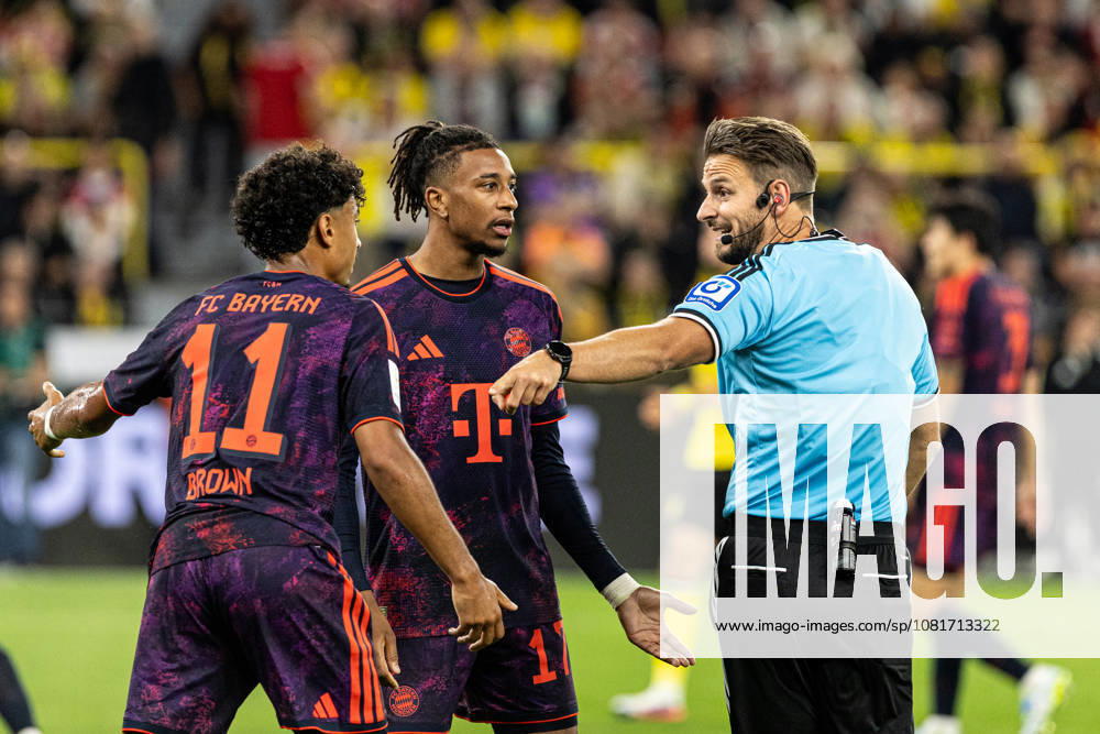 Franz-Beckenbauer-Supercup 2026: Borussia Dortmund - FC Bayern München; 22.08.2026 Daniel Schlager (Schiedsrichter, Bietigheim), Michael Olise (FC Bayern München, 17), Nathaniel Brown (FC Bayern München, 11) Franz-Beckenbauer-Supercup 2026: Borussia Dortmund - FC Bayern München; Signal Iduna Park, Dortmund