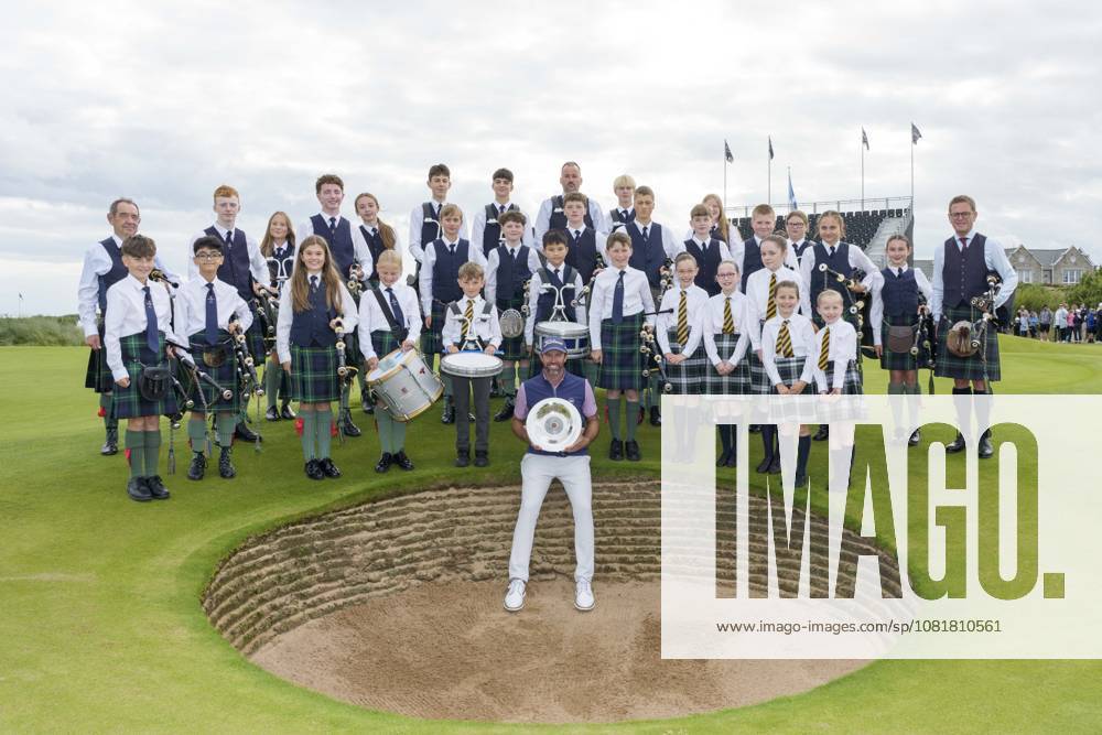 BALMEDIE, SCOTLAND - AUG 23: Scott Jamieson (SCO) holds the Nexo Trophy with the Robert Gordon Academy Pipe band after Round 4 at the 2026 Nexo Championship at the Trump International Golf Links, Balmedie on August 23, 2026 in Aberdeenshire, Scotland The 2026 Nexo Championship