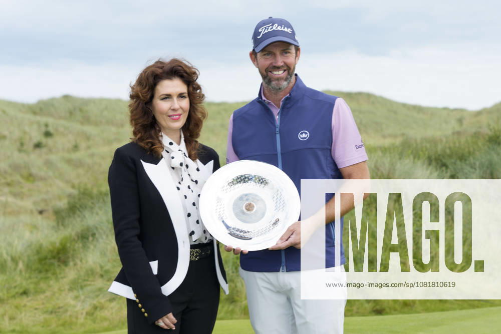 BALMEDIE, SCOTLAND - AUG 23: Scott Jamieson (SCO) receives the Nexo Trophy from Sarah Malone Head of the Trump International after Round 4 at the 2026 Nexo Championship at the Trump International Golf Links, Balmedie on August 23, 2026 in Aberdeenshire, Scotland The 2026 Nexo Championship