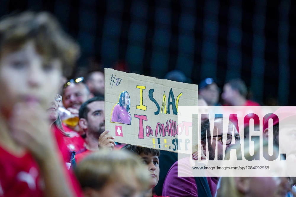 Fussball UEFA Nations League 2026 - 2027, 3. Spieltag - Schweiz vs Slowenien - Thermoplan Arena (Luzern): Schweizer Fans auf der Tribüne mit selbst gestaltetem Fanplakat für Isaac Schmidt mit der Aufschrift ISAAC Ton Maillot SJP und der Nummer 17. Cedric Itten (Schweiz, 17) Zuschauer, Fans, Schweiz, Schweizer Nationalmannschaft, Nati, Isaac Schmidt, Fanplakat, Transparent, Spruchband, Trikot, Maillot, Unterstützung, Fankultur, Tribüne, Fußball, UEFA Nations League