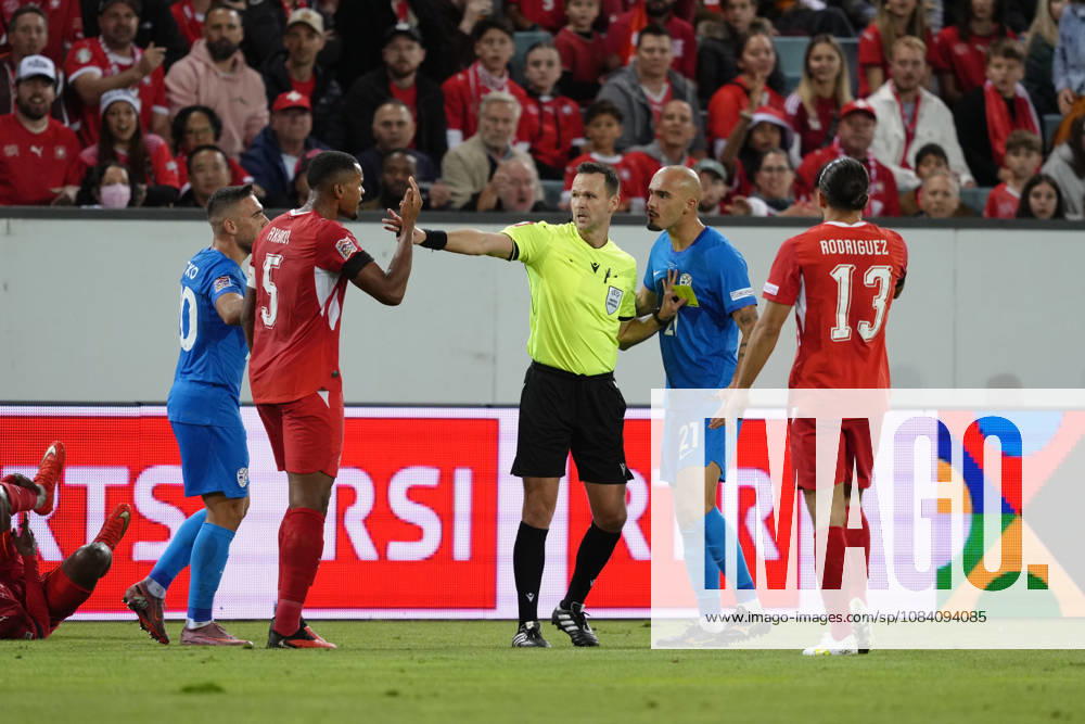 Vanja Drkusic (21 SLO) is attacking Manuel Akanji (5 SUI) Referee Ivan Kruzliak in between during the UEFA Nations League match between Switzerland and Slovenia at thermoplan arena on October 03, 2026 in Luzern, Switzerland.