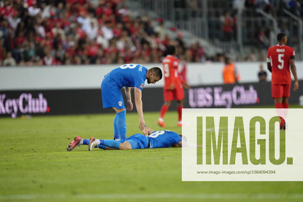Zan Vipotnik (18 SLO) is looking for Sandi Lovric (8 SLO) who lies in the pitch during the UEFA Nations League match between Switzerland and Slovenia at thermoplan arena on October 03, 2026 in Luzern, Switzerland.