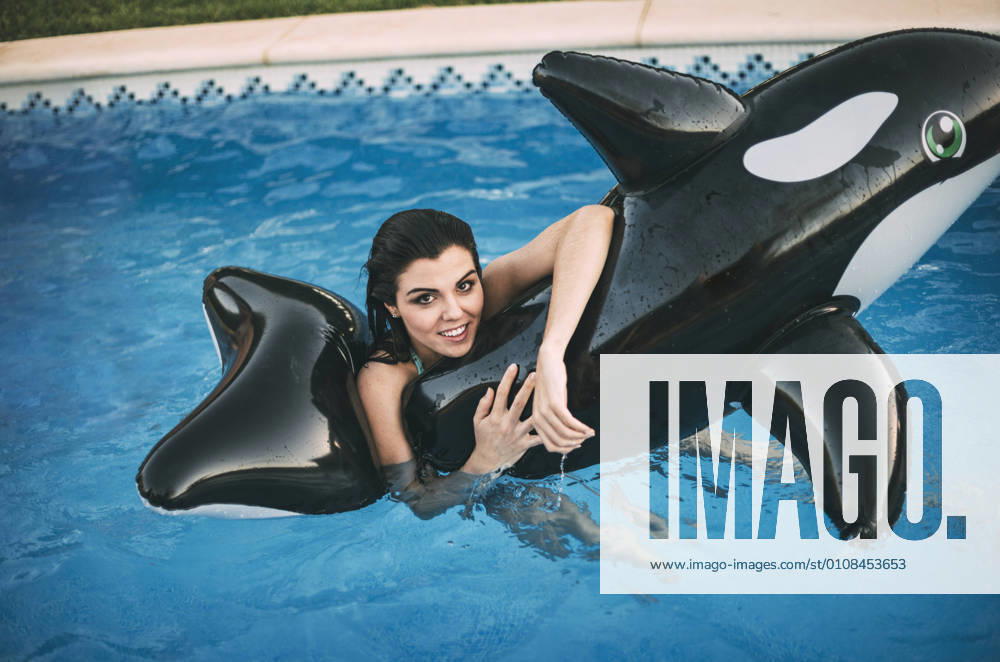 Girl with inflatable toy posing in water, Model released, Property released