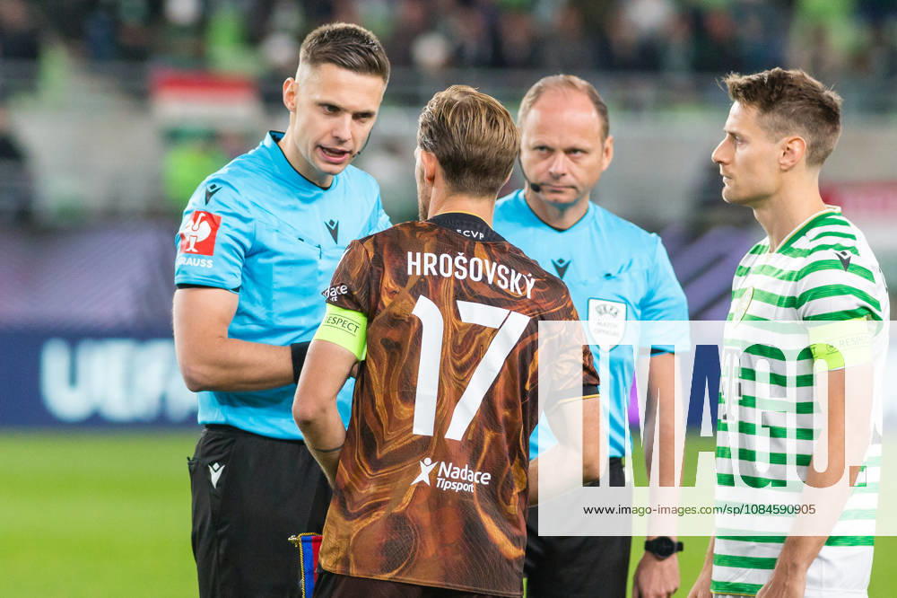 Ferencvaros v Viktoria Plzen, UEFA Europa League, Budapest, Hungary Budapest, Hungary. 15th, October 2026. Referee Damian Sylwestrzak seen with captains Patrik Hrosovsky (17) of Viktoria Plzen and Kristoffer Zachariassen (R) of Ferencvaros during the UEFA Europa League match between Ferencvaros and Viktoria Plzen at Groupama Arena in Budapest. Hungary, Budapest, Groupama Arena
