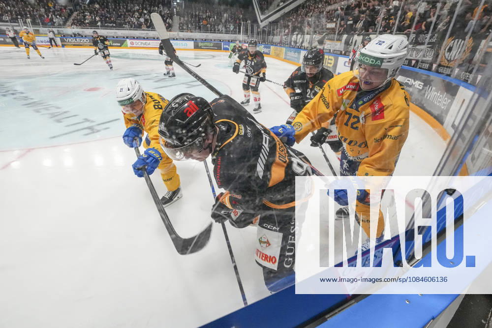 Daniel Olsson of Lugano C) against Julian Parree of Davos L) and Tino Kessler of Davos R) during the game between HC Lugano v HC Davos at the Corner Arena on October 16, 2026 in Lugano, Switzerland. Lugano Ticino Switzerland