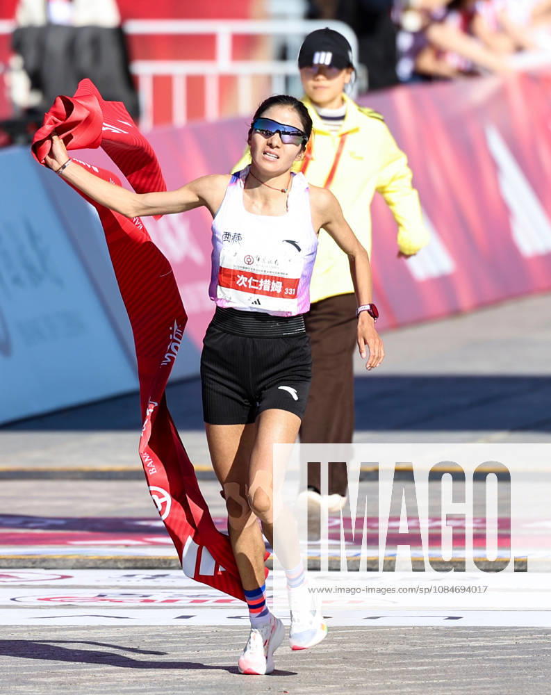(261018) -- BEIJING, Oct. 18, 2026 -- Cirencuomu of China crosses the finish line to win the second place of the women s marathon event at the 2026 Beijing Marathon & National Marathon Championships in Beijing, capital of China, Oct. 18, 2026. ) (SP)CHINA-BEIJING-2026 BEIJING MARATHON (CN) LuoxYuan