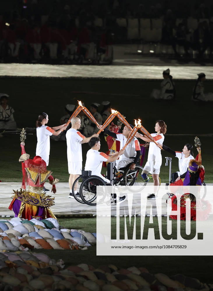 (261018) -- NAGOYA, Oct. 18, 2026 -- Torch bearers hand over the flame during the opening ceremony of the Aichi-Nagoya Asian Para Games in Nagoya, Japan, Oct. 18, 2026. ) (SP)JAPAN-NAGOYA-ASIAN PARA GAMES-OPENING CEREMONY YaoxQilin