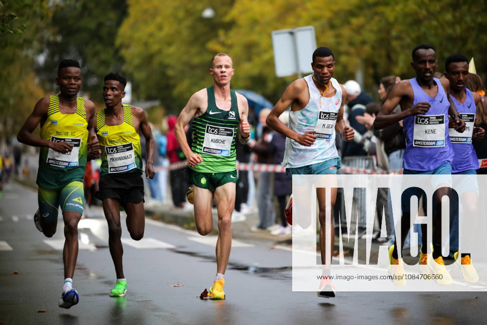 18th October 2026; Amsterdam, Netherlands; TCS Amsterdam Marathon; George Kusche of South Africa (centre) runs alongside Mayko Geay of Tanzania and Getachew Kene of Ethiopia (right) in a group of runners along Beethovenstraat AnthonyxBenoit