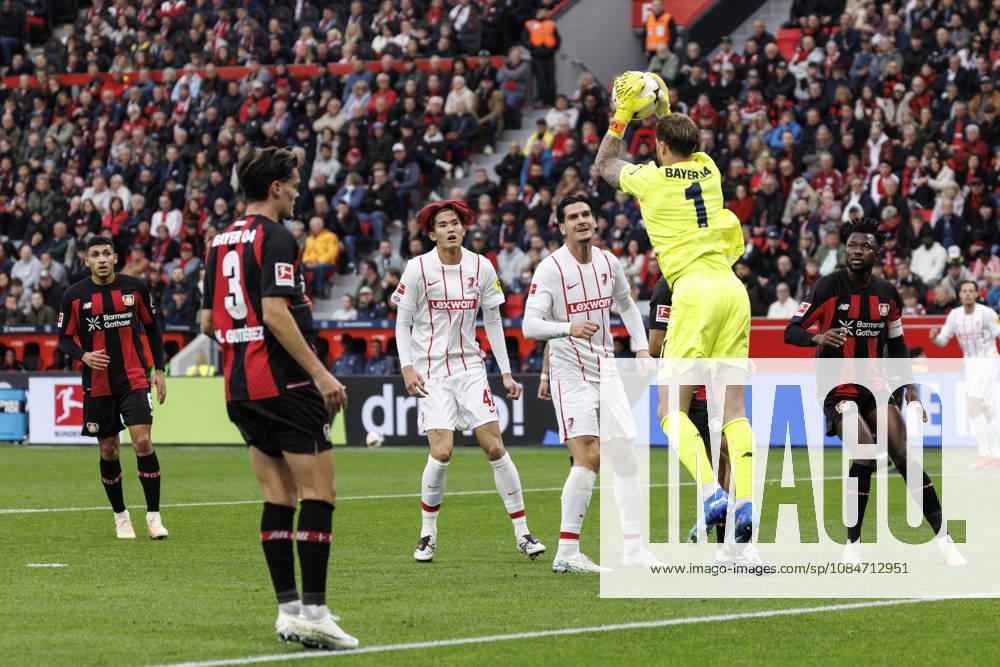 Mark Flekken (Bayer 04 Leverkusen, 1) saves the ball before Keisuke Goto (SC Freiburg, 42) and Igor Matanovic (SC Freiburg, 31) during the German Bundesliga match on gameday 6 between Bayer 04 Leverkusen vs. SC Freiburg at BayArena on October 18, 2026 in Leverkusen, Germany. DFL REGULATIONS PROHIBIT ANY USE OF PHOTOGRAPHS AS IMAGE SEQUENCES AND OR QUASI-VIDEO. Northrhine-Westphalia Germany