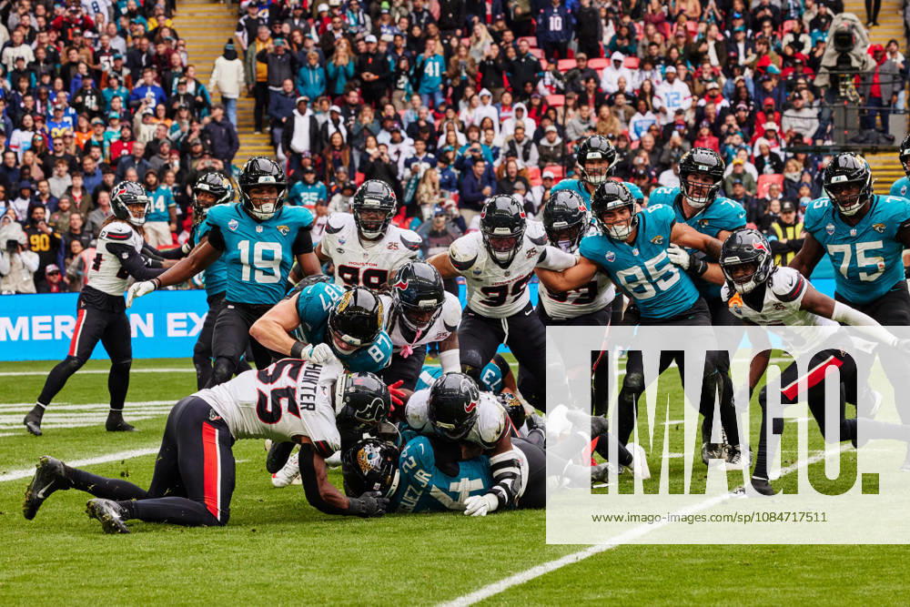 18th October 2026; Wembley Stadium, London, England; NFL, American Football Herren, USA American Football, Jacksonville Jaguars versus Houston Texans; Chris Rodriguez Jr of the Jacksonville Jaguars, RB is tackled by Danielle Hunter (55) of the Houston Texans, DE MattxBenxStone