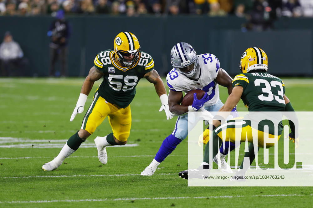 GREEN BAY, WI - OCTOBER 18: Dallas Cowboys running back Javonte Williams (33) tries to escape the tackle of Green Bay Packers safety Evan Williams (33) and Green Bay Packers linebacker Isaiah McDuffie (58) during a game between the Green Bay Packers and the Dallas Cowboys on October 18, 2026 at Lambeau Field in Green Bay, WI. (Photo by Larry Radloff Icon Sportswire) NFL, American Football Herren, USA OCT 18 Cowboys at Packers Icon2610181009