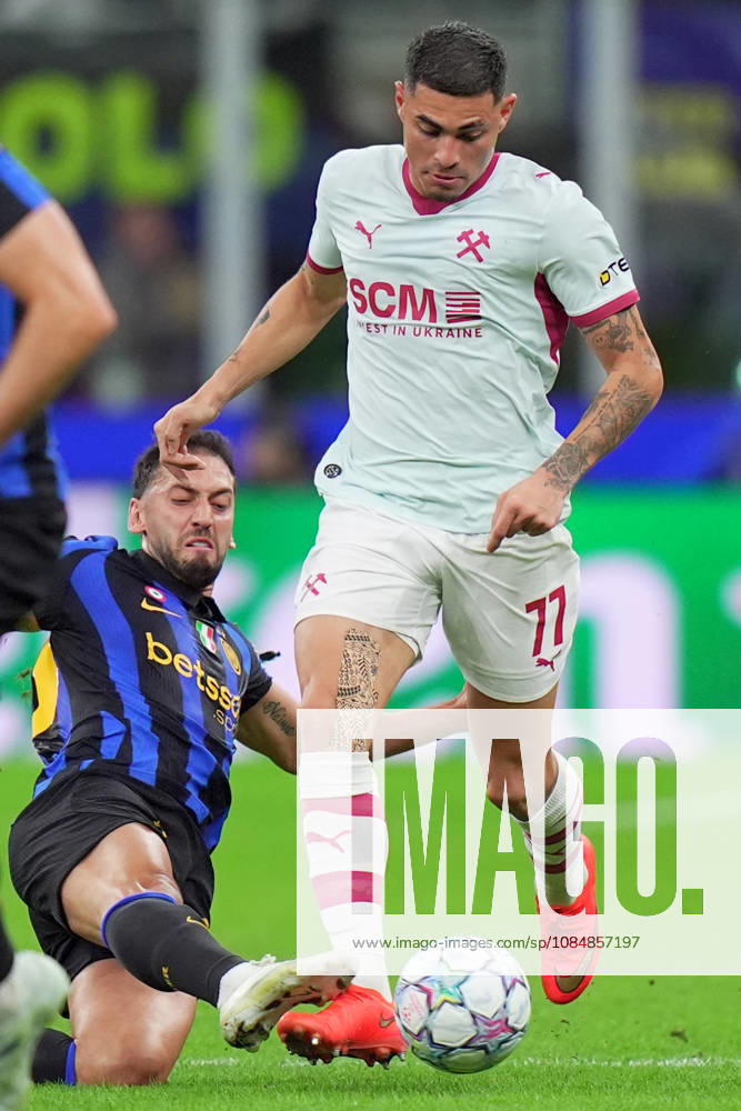 Shakhtar s Gleiker Mendoza , Inter Milan s Hakan Calhanoglu during the Uefa Champions League soccer match between Inter and Shakhtar Donetsk at San Siro Stadium in Milan , Italy - Wednesday October 21 , 2026. - Soccer