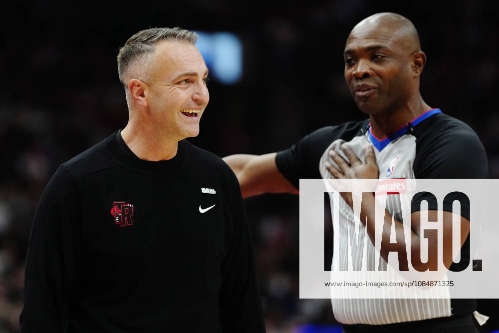 Toronto Raptors head coach Darko Rajakovic laughs while speaking with referee Courtney Kirkland (61) during first half NBA, Basketball Herren, USA basketball action against the Chicago Bulls in Toronto on Wednesday, Oct. 21, 2026. Canada News - October 21, 2026 - ZUMAc35_ 20261021_zaf_c35_255