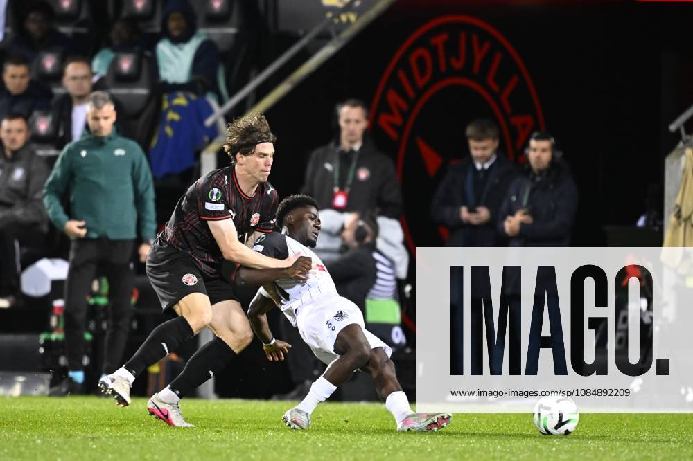 FC Midtjylland v Sint-Truidense VV - UEFA Conference League HERNING, DENMARK - OCTOBER 22 : Bech Mads defender of Midtjylland and Mbuku Nathanael forward of Sint-Truidense VV during the UEFA Conference League 2026 27 League Phase matchday 2 match between FC Midtjylland and Sint-Truidense VV on October 22, 2026 in Herning, Denmark, 22 10 2026 Herning Denmark