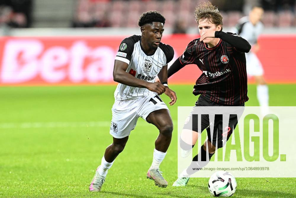 Midtjylland s Sofus Johannesen and STVV s Nathanael Mbuku pictured in action during a soccer game between Danish FC Midtjylland and Belgian Sint-Truidense VV, Thursday 22 October 2026 in Herning, Denmark, on the second day of the UEFA Conference League league phase. JILLxDELSAUX x190690552x