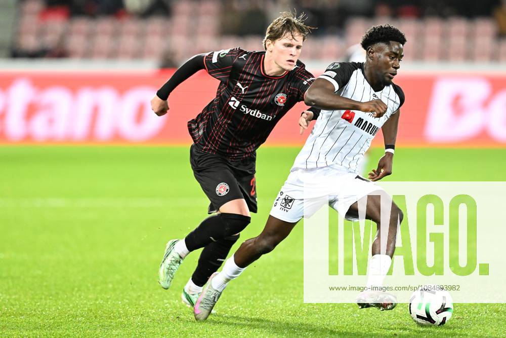Midtjylland s Sofus Johannesen and STVV s Nathanael Mbuku pictured in action during a soccer game between Danish FC Midtjylland and Belgian Sint-Truidense VV, Thursday 22 October 2026 in Herning, Denmark, on the second day of the UEFA Conference League league phase. JILLxDELSAUX x190690559x