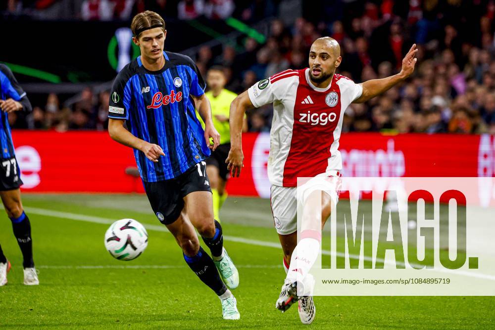 AMSTERDAM - Sofyan Amrabat of AFC Ajax passes the ball under pressure from Charles De Ketelaere of Atalanta BC during the UEFA Conference League match between AFC Ajax and Atalanta BC at the Johan Cruijff ArenA on October 22, 2026 in Amsterdam, the Netherlands. WART BRINKERHOF ANP Conference League 2026 27 ANPxSportx xMarcelxterxBalsxIVx 573299784 originalFilename: 573299784