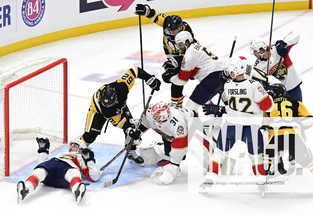 Pittsburgh Penguins left wing Andrei Kuzmenko (62) and Penguins center Hendrix Lapierre reaches for the puck as Florida Panthers right wing Garnet Hathaway (21) protects the goal with his body during the second period at PPG Paints Arena in Pittsburgh on Thursday, October 22, 2026. PIT2026102209 ARCHIExCARPENTER