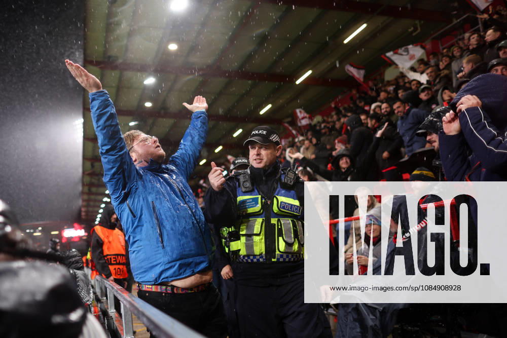 Bournemouth v AC Milan 22 October 2026, Bournemouth - UEFA Europa League - Bournemouth v AC Milan - A Bournemouth fan attempts to rile up the Curva Sud but a police officer stops him - Photo: Jacques Feeney Offside. Bournemouth UK