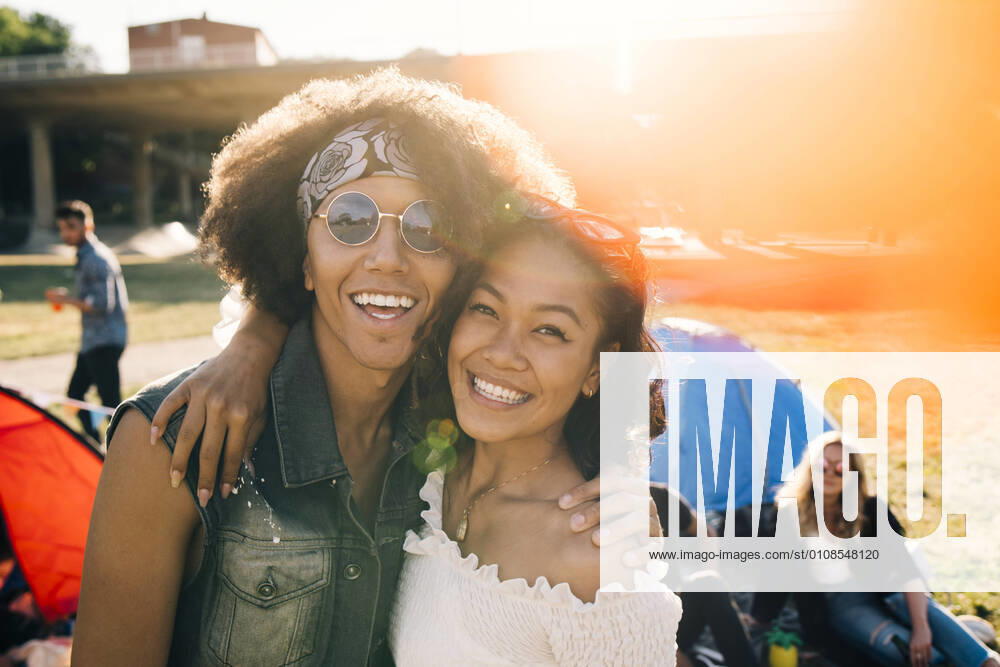 Portrait of smiling friends enjoying at music festival during summer , model released