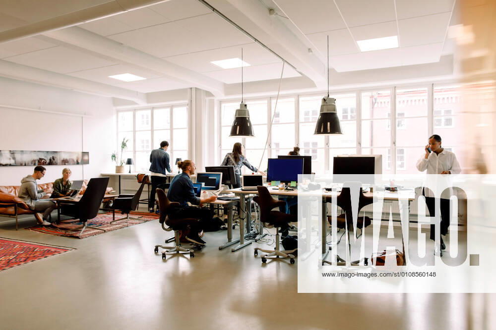 Male and female entrepreneurs working in creative office , model released, property released