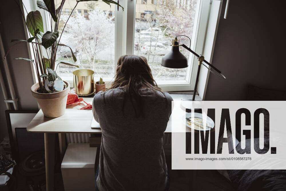 IMAGO Creative: Gesundheit, Burnout IMAGO Creative: 2021 Trends Rear view of worried woman sitting against window Sweden, Stockholm, model released, property released