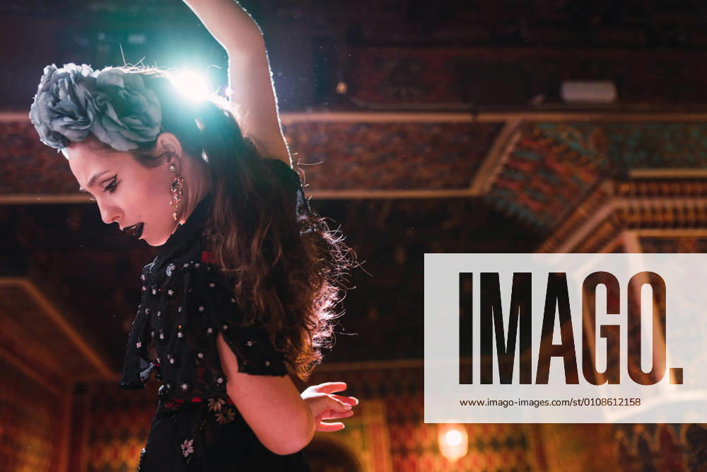 Young lady in dress dancing flamenco on scene in luxury oriental room decorated by mosaic, Model released, Property released
