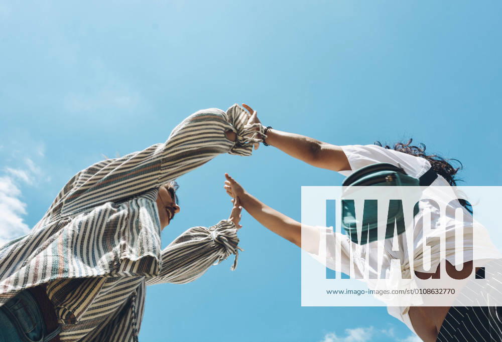 IMAGO Creative: Gesellschaft, Integration Group of friends embraced and putting their hands together. All of them very happy and showing happiness, Model released